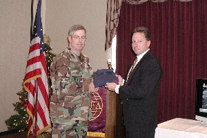 OKLAHOMA CITY Col. Bruce Harmon (l), USAF, director, Oklahoma City Air Logistics Center Information Technology Directorate and president of AFCEA-OKC, presents Mr. Tim Kiernan, Director of Sales, North America, LifeSize Communications, with a gift for his presentation at the December chapter luncheon.  